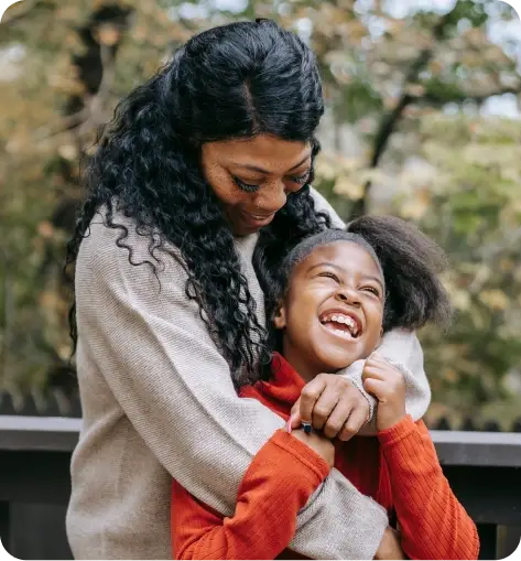 a mother hugging her daughter