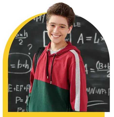 photo of a boy smiling with a blackboard as a background