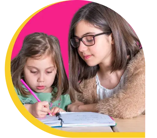 a girl guiding a little girl to write