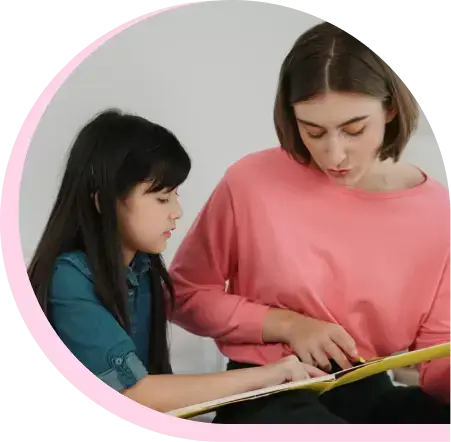 woman reading something to a girl