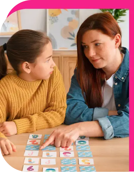 a girl and a woman looking at flash cards