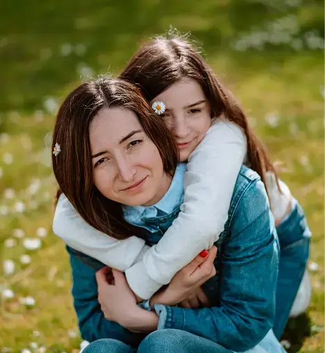 girl hugging a woman from behind