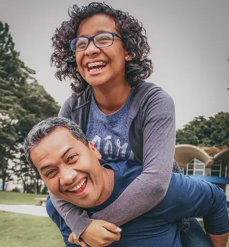 a father giving his son a piggyback