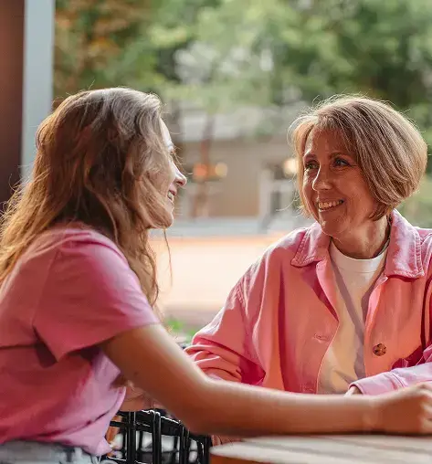 two woman talking and smiling