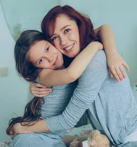 a woman and a child hugging