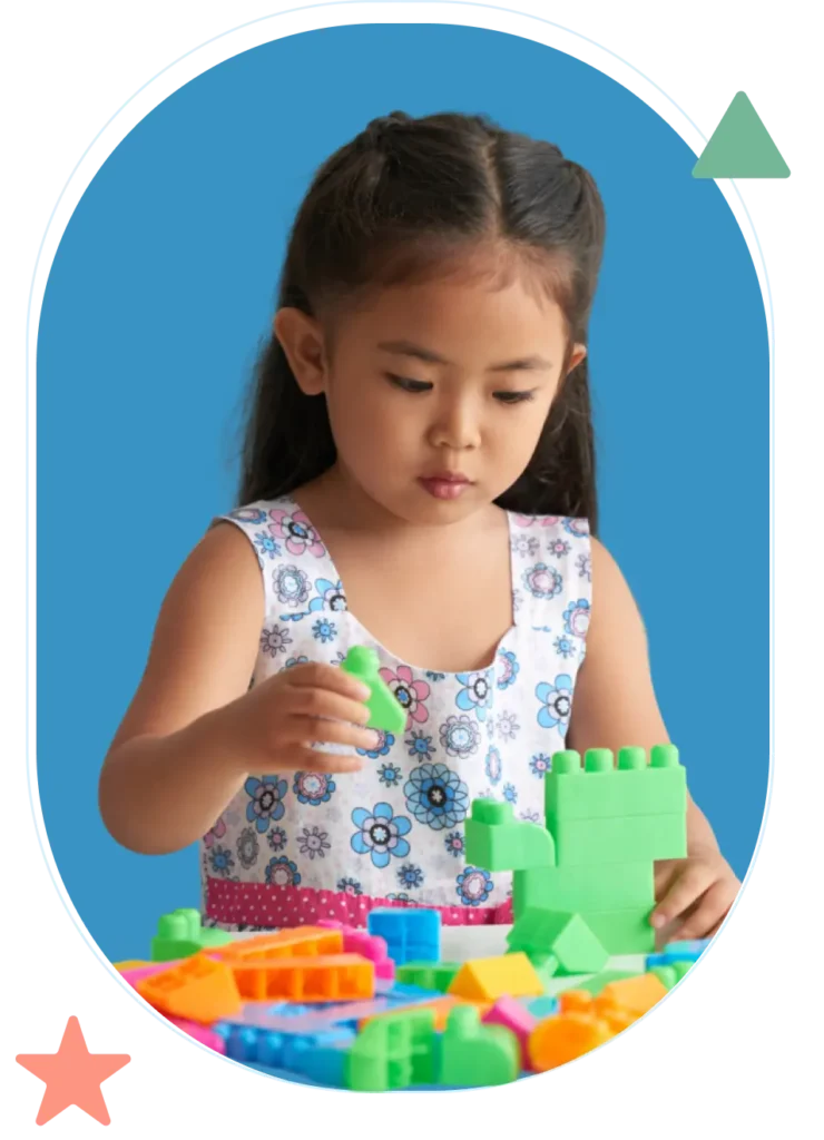 a young girl playing lego blocks