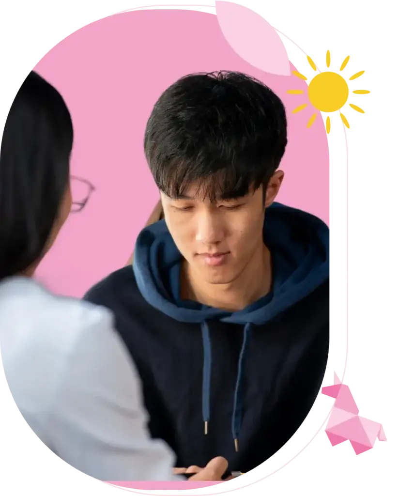 a boy looking down while talking to a woman